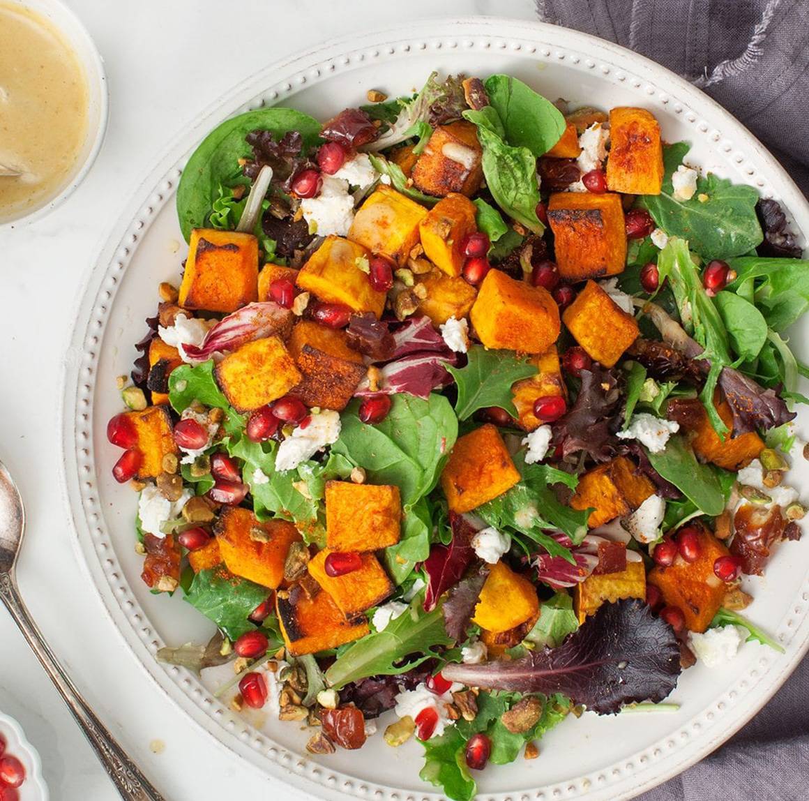 Butternut squash salad (Mixed greens, pumpkin seeds, tomatoes, red onion, feta cheese, purple cabbage, with a spicy chipotle avocado sauce)